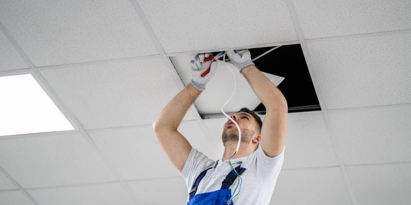 Electrician installing light